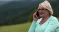 Woman talking on a cell phone on the nature HD Footage