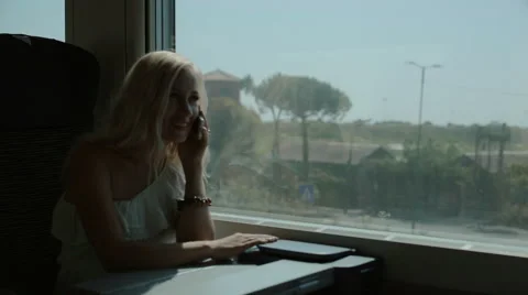 Woman talking on cell phone in the train Stock Footage 59805136