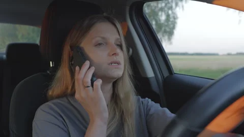 Woman talking on a cell phone while driving Video stock 278407501
