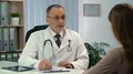 Woman talking to doctor, physician prescribing medication to patient in clinic HD Footage