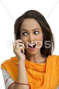 Woman talking on a mobile phone and looking surprised Stock Photos
