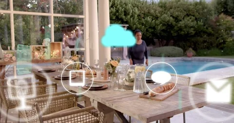 Woman talking on phone causing teal cloud and app icons animating over wooden Stock Footage 322203258