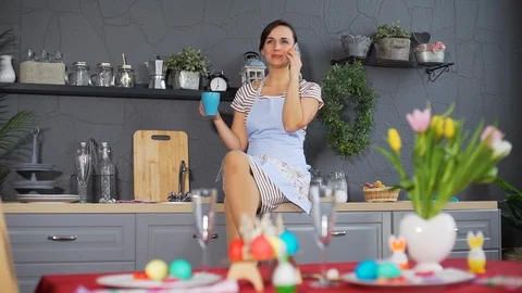 Woman Talking on the Phone Before Easter Dinner Stock Footage 124523118