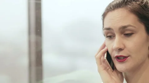 Woman talking on the phone in a moving elevator Stock Footage 59781195