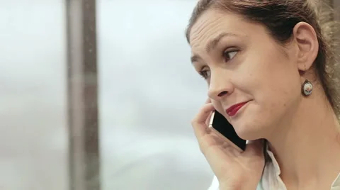 Woman talking on the phone in a moving elevator Stock Footage 59782038