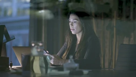 Woman talking on the phone while working in office Stock Footage 112059267