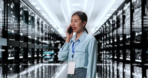 Woman Talking On Smartphone While Working In Server Room Database Stock Footage 248004706