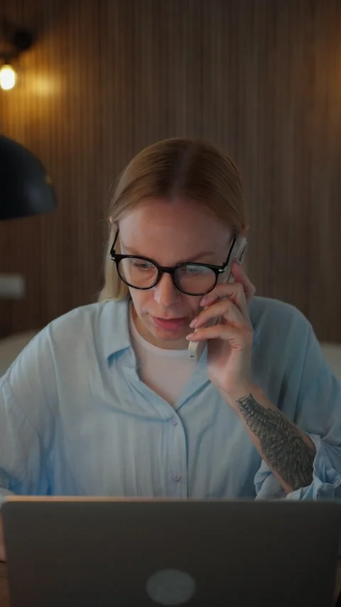 Woman talking on smartphone while working remotely from home, multitasking .. Stock Footage 327490388