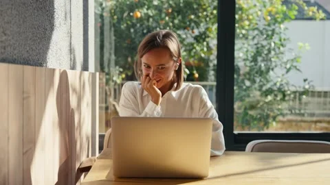 A woman is talking with someone using her laptop computer and video connection Stock-Footage 228462020