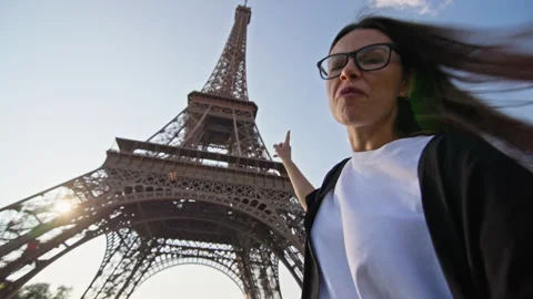 Woman talking on video call with Eiffel Tower in Paris in the background. Stock Footage 315290147