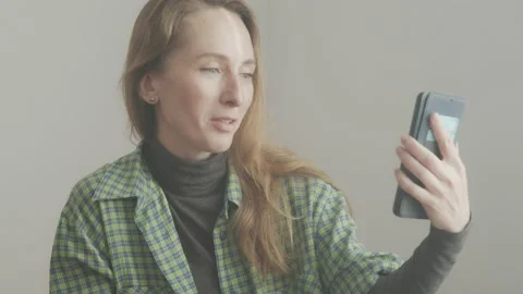A woman is talking on a video link through a smartphone. Friendly dialogue. Stock Footage 233011035