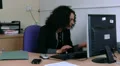 Woman talks about files on phone to colleague HD Footage