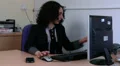 Woman talks on phone to a colleague HD Footage