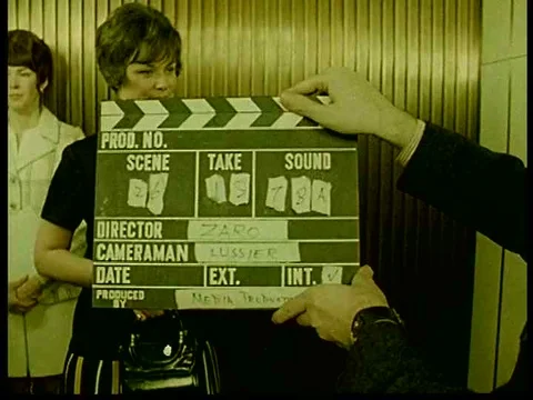 A woman talks to someone off screen while holding a brown paper bag in an Stock Footage 75763563