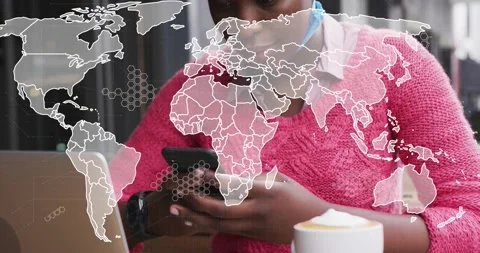 Woman tapping phone in cafe, causing fading world map overlay over laptop, cup, 動画素材 320725042
