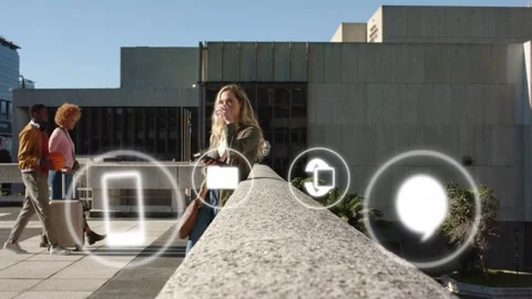 Woman tapping phone checking mail in plaza, causing floating tech icons cycling Stock Footage 333019620