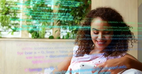 Woman tapping phone on sofa, causing code overlay while exploring tech content Stock Footage 321070561