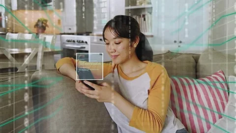 Woman tapping phone on sofa causing 3D data grid marking phone or head, peaking Stock Footage 334202523
