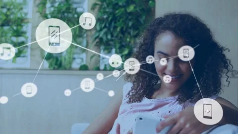 Woman tapping phone on sofa, spawning icons linking, drifting and obscuring her, Stock Footage 333901179