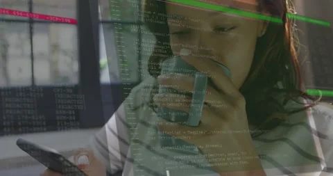 Woman tapping phone by window, causing growing tech code overlay while sipping Stock Footage 329700178