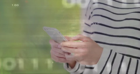 Woman tapping smartphone activating binary code and circuit patterns on hands Stock Footage 310972460