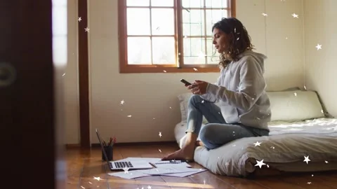 Woman tapping smartphone, checking laptop papers by window, stars moving around Stock Footage 333632058