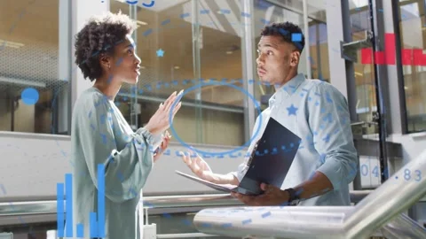 Woman tapping stylus and explaining finance, man holding laptop, charts Stock Footage 332704789