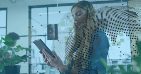 Woman tapping tablet, activating dotted world-map overlay in business, analyzing Stock Footage 334033883
