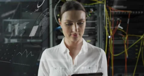 Woman tapping tablet, activating HUD maps and graphs over server racks while Stock Footage 331269886