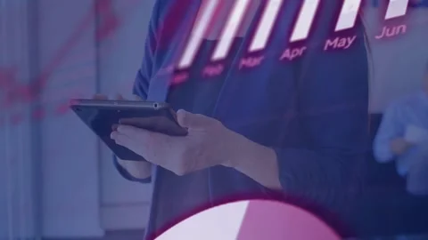 Woman tapping tablet, activating red code overlay and month bar chart, Stock Footage 332504720