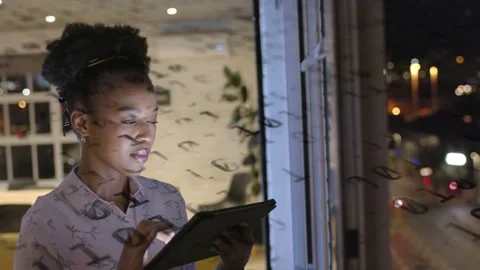 Woman tapping tablet and analyzing data for tech, code reflections moving across Stock Footage 333552962