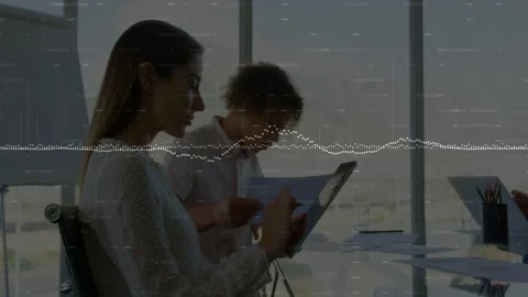 Woman tapping tablet and man reading docs, for business review, dotted waveform Stock Footage 333062535