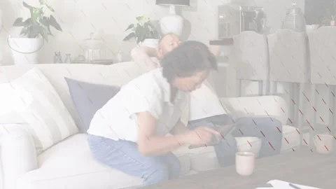 Woman tapping tablet and reaching papers on coffee table, sharing tech content Stock Footage 333526525