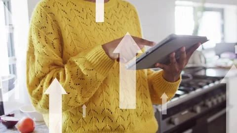 Woman tapping tablet causing up arrows over screen, pulling back revealing face Stock Footage 335317293