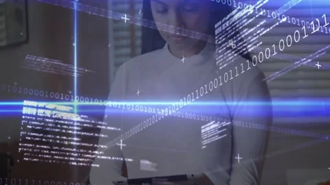 Woman tapping tablet corner in tech studio initiating binary code and scrolling Stock Footage 327127944