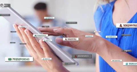 Woman tapping tablet at counter, creating number labels and icons visualizing Stock Footage 317351997