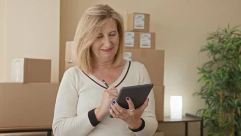 Woman tapping tablet with hands while checking packages and parcels in a sm.. Stock Footage 339148347