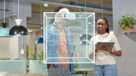 Woman tapping tablet initiating tech demo while man wearing VR headset Stock Footage 334373313