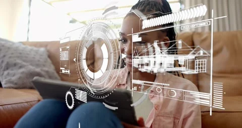 Woman tapping tablet screen, causing circular HUD to expand into wireframe house Stock Footage 320895700