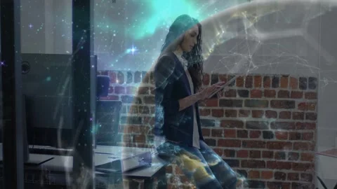 Woman tapping tablet in tech office, globe overlay growing around her, Stock Footage 332544687