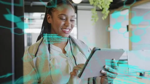 Woman tapping tablet in tech office and activating turquoise code across glass, Stock Footage 333540034