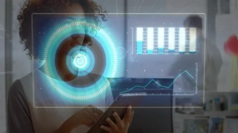 Woman tapping tablet in tech office, starting AR HUD overlaying tablet, Stock Footage 333733336