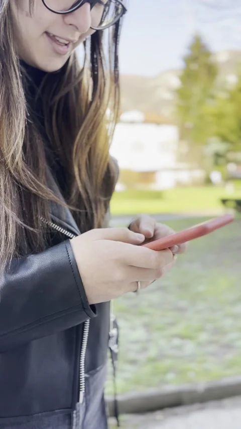 A woman tayping a message on a smartphone. Vertical video Stock Footage 236100739