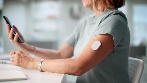 Woman Testing Glucose Level With Continuous Glucose Monitor Stock Footage 314935276