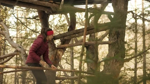 Woman Testing The Structure Integrity Of A Treehouse In The Woods. Video stock 101682001