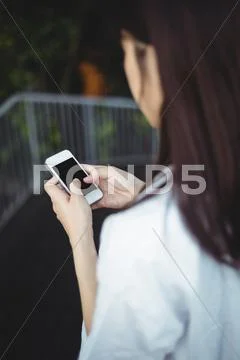Woman Text Messaging On Mobile Phone