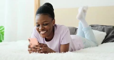 Woman text messaging using mobile phone on bed Stock Footage 155112618