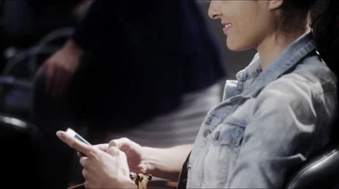 Woman text messaging while waiting for a haircut Stock-Footage 52258380