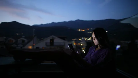 Woman texting and chat using phone at home balcony in the evening Stock Footage 127981970