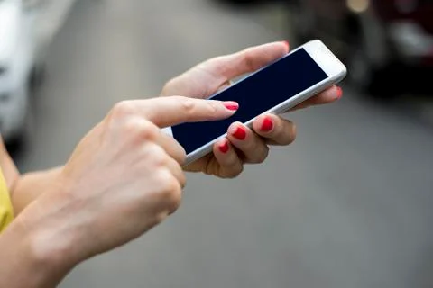 Woman texting on her mobile phone outdoor Stock Photos